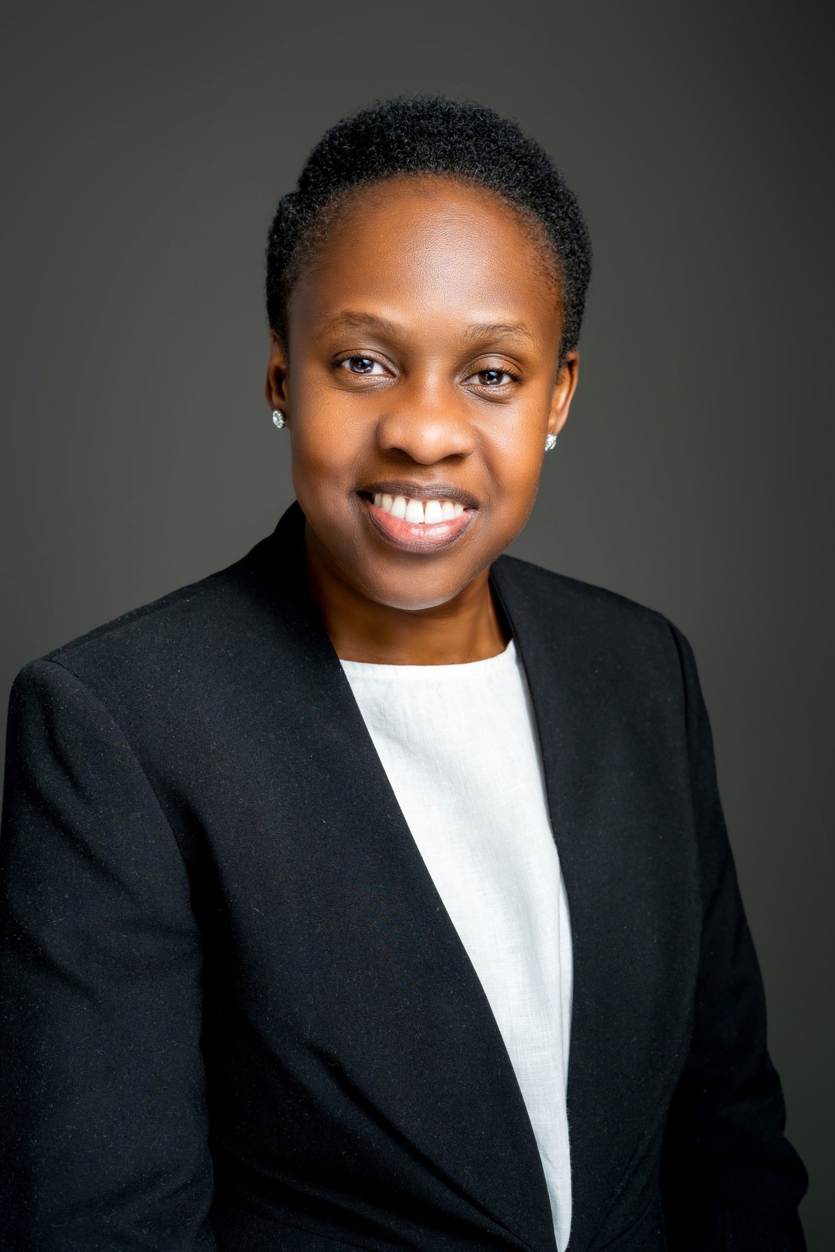 Professional headshot of a woman in a dark jacket